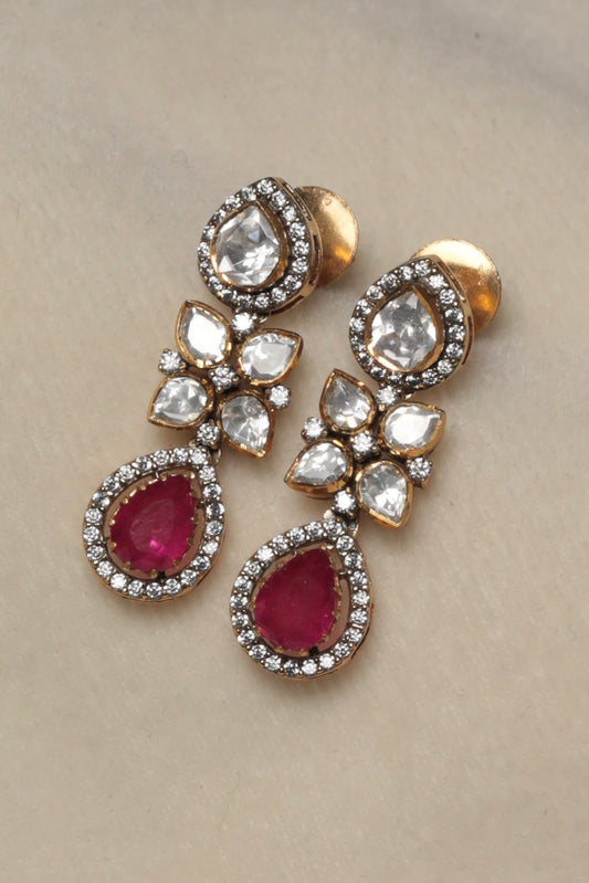 Silver Finish Kundan Drop Earrings with Ruby Red Teardrops
